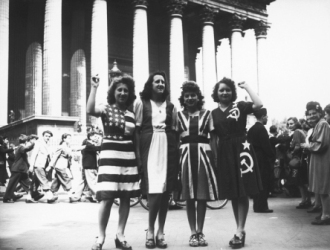 A group of women wearing dresses representing flags of the Allied powers (left to right: the USA, France, Britain and the Soviet Union) outside the Eglise de la Madeleine on VE Day in Paris, 8th May 1945. (Photo by Keystone/Hulton Archive/Getty Images)